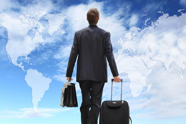 Business person with suite case and clouds are a world map