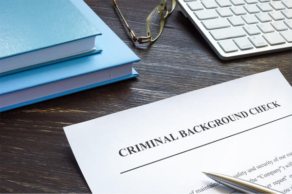 Criminal background check request form with pen.