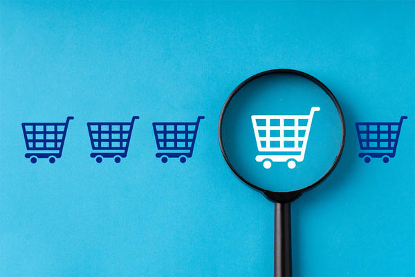 Online shopping & business icon on retro computer keyboard with magnifying glass