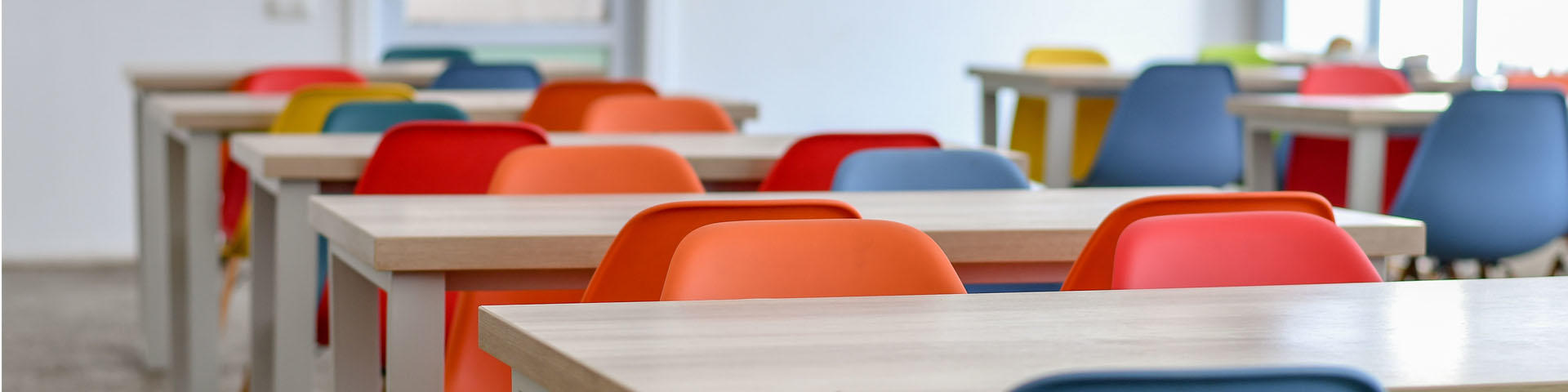 colorful chairs in the empty school dining room.