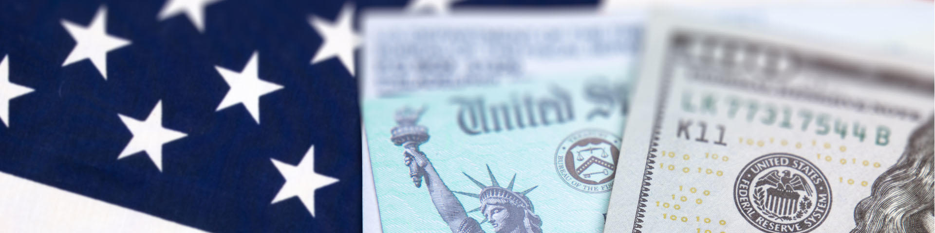 United States IRS Check. Envelope and Money Resting on American Flag.