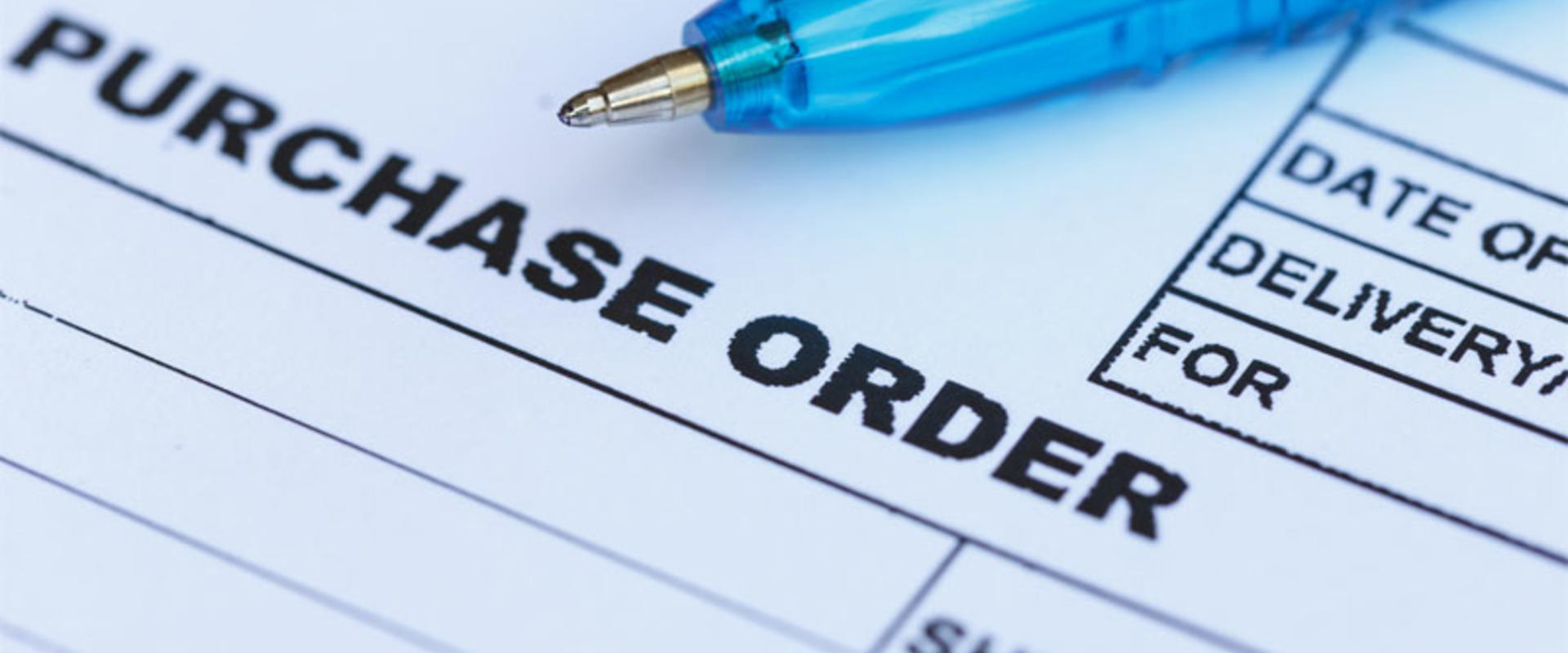 purchase order with blue pen in the office